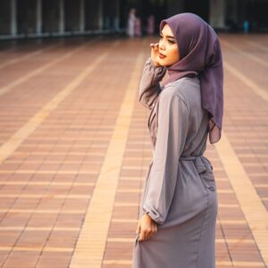 Portrait of a woman in stylish hijab standing at Istiqlal Mosque, Jakarta. Captures beauty and cultural grace.